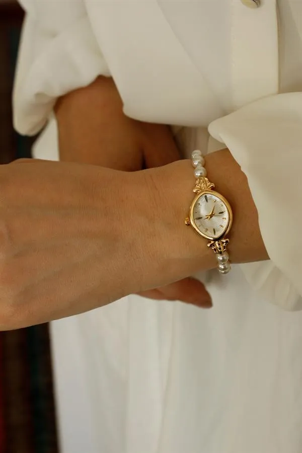 <tc>Montre pour femme Pearl Gold Metal, avec perles, cadran doré.</tc>
