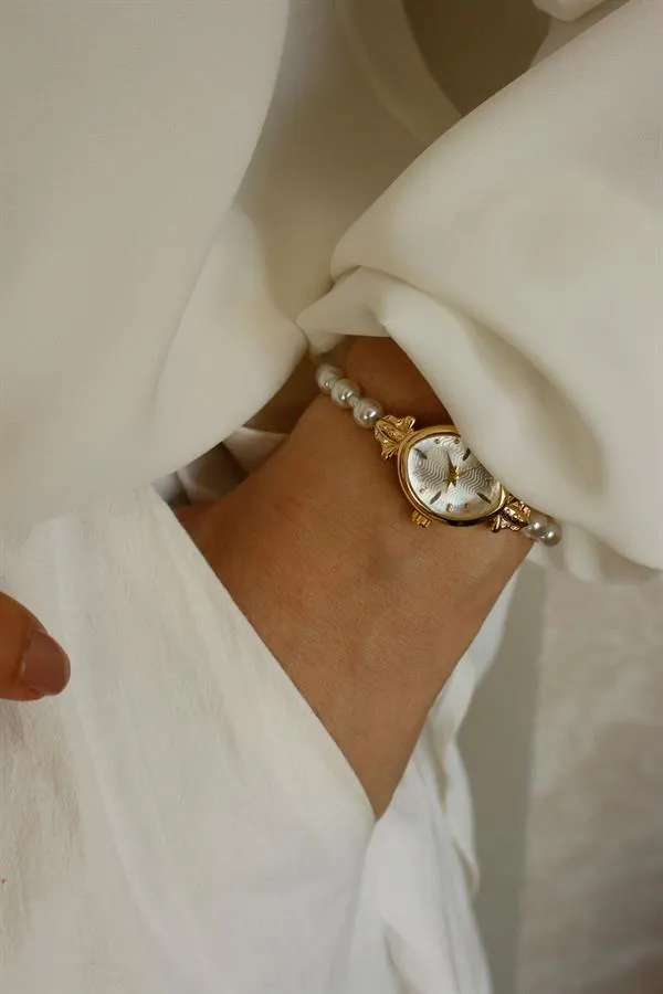 <tc>Montre pour femme Pearl Gold Metal, avec perles, cadran doré.</tc>